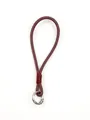 Macro view of handmade burgundy leather phone wrist strap with silver spring ring buckle - Burgundy