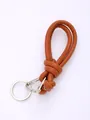 Close-up of handmade woven PU leather lanyard with silver metal clasp and knot design. - Brown (20849)