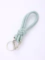Detail view of light green handmade PU leather knotted keychain with silver metal rings. - Light Green (20845)