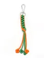 Detailed view of handmade orange and green paracord keychain with woven corn knot pattern - Orange and Green Contrast