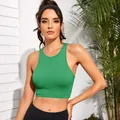 Front view of a green ribbed sports crop top on model for fitness and yoga sessions - S / Tops / Grass Green