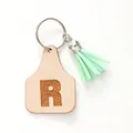 Minimalist cow tag leather keychain with letter R and a mint green tassel charm - Letter R Style (20448)