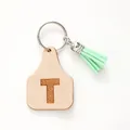 Personalized ear tag keychain with letter T and light green tassel detail - Letter T Style (20450)