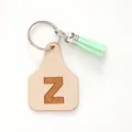 Farmhouse style leather cow tag keychain featuring letter Z and a mint green tassel - Letter Z Style (20456)