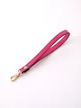 Elegant pink faux leather wrist strap featuring a polished gold-toned lobster clasp - Rose Pink