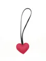Detailed close-up of a red leather heart-shaped pendant with minimalist black strap - Heart Charm / Red