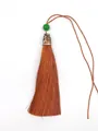 Close-up detail of a silky brown polyester tassel with a green bead and silver metal cap - Green Bead & Alloy Cap Style / Bronze