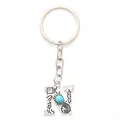 Stylish alloy letter N keychain featuring a turquoise bead and engraved bohemian patterns - 20492