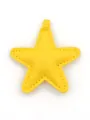 Detailed view of a yellow leather star-shaped bag charm with fine decorative stitching - Star Pendant / Yellow