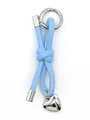 Macro shot of a light blue leather cord knot keychain with a silver heart charm. - Woven Lanyard (21675)