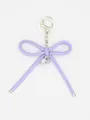 Close-up of minimalist purple leather bow keychain with silver heart pendant ornament - Bowknot Charm (22427)