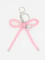 Detail view of pink leather bow keychain with silver heart charm and lobster clasp - Bowknot Charm (22425)