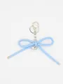 Close-up of blue woven leather bow keychain with silver heart charm and lobster clasp - Bowknot Charm (22424)