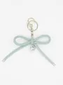 Close-up of a Morandi blue leather bow keychain with a shiny silver heart charm. - Bowknot Charm (22423)