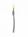 Detailed macro view of a stylish grey handmade woven PU leather keychain with a gold clasp - Hand-woven Pendant (22165) / Gray