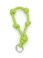 Close-up of vibrant lime green knotted leather strap bag charm with silver metallic ring - Bright Green