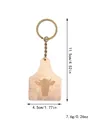 Rustic wooden keychain with laser-engraved cow head design and antique brass ring. - Bull Head Shield (20323)