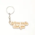 Portachiavi in legno con incisione laser 'drive safe i love you' su fondo bianco. - drive safe i love you (20344)