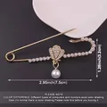 Detailed macro view of a gold shell pearl safety pin brooch with size measurements - Shell Pendant Large Brooch / Gold (Pearl Pendant)