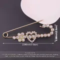 Detailed view of heart-shaped rhinestone safety pin brooch with size labels 7.5cm x 2.5cm - Heart and Plum Blossom Shape / Gold