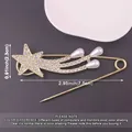 Detailed macro view of the star-shaped metal safety pin brooch with dimension markings - Shooting Star Design / Gold
