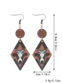 Detailed view of Western style wood earrings with cow print and product dimensions - Bull Head with Bow Rhombus (11696)