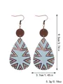 Western style teardrop wooden earrings with geometric sunburst pattern and size info - Radial Mountain Texture (11656)