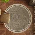 Modern round geometric carpet with black and cream interlocking pattern on wooden floor - Diameter 60cm / Honeycomb Geometric (Labyrinth Wisdom)