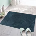 Detailed view of thick absorbent dark blue plush cake velvet door mat on wooden floor - 40x60cm / Dark Blue
