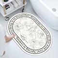 White oval absorbent diatomaceous earth bath mat with elegant floral pattern and text - Floral Breeze (Oval) / 40*60cm