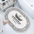 Oval lamb wool bathroom mat in white with black circular text and tub illustration - 40*60cm / Bathtub (Oval)