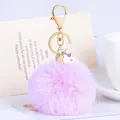 Llavero de pompón de piel sintética violeta con un bonito amuleto de unicornio - Unicornio - Púrpura Claro