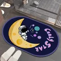 Detailed view of a non-slip diatom mud bathroom mat with cute astronaut cartoon design - Moon Astronaut