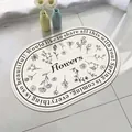 Oval white lamb wool non-slip bathroom floor mat with black floral pattern design - 40*60cm / Dreamy Flower Whisper (Oval)