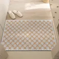Detail view of a brown and white geometric silk loop doormat on a wooden floor. - 40*60cm / Dream Style