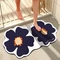 Absorbent bath mat with black flower pattern shown in a real bathroom shower setting. - 40*60cm / Black and White Wavy Edge Style