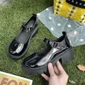 Close-up of black patent leather Mary Jane platform shoes with chunky block heels. - Patent Black (1591)