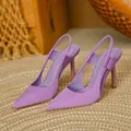 Side detail of elegant purple satin pointed-toe slingback high-heel pumps on a woven mat - Purple