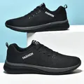 Macro side view of black breathable knit low-top running sneakers with fashion text - 36 / Black and Gray