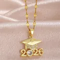 Close-up macro detail of golden graduation cap necklace pendant with 2026 and sparkling crystals - 2026 Year Rhinestone Style / Gold