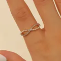 Close-up detail of elegant gold-toned infinity ring featuring pearls and sparkling crystals - Adjustable Open / Pearl Rhinestone Infinity Shape (5355) / Rose Gold