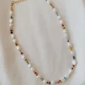 Close-up of handmade baroque freshwater pearl necklace with colorful mixed seed beads - Short Choker Length / Rainbow Striped