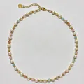Macro view of freshwater pearl necklace with colorful beads and gold heart charm - Short Choker Length / Multicolor Gold-Spaced