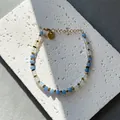 Gefacetteerde natuurstenen kralenarmband met blauwe kralen en een gouden hartbedeltje - Eén maat / Blauw Wit Geslepen Steen Stijl (14) / 17+3cm