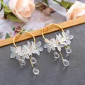 Elegant gold hoop earrings with frosted white floral petals and clear crystal charms - Three-layer Ice Flower Tassel (10991)