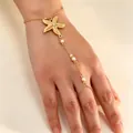 Elegant gold starfish hand chain bracelet featuring delicate white pearl accents on skin - Starfish Artificial Pearl Ring-Linked Bracelet (X239) / Gold (X239)