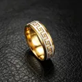Close-up detail of titanium steel ring with gold Greek meander pattern on black leather. - Size 7 / 6mm Greek Key Style / Two-tone Gold Silver