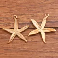 Ein Paar exquisite goldene Seestern-Metallanhänger für DIY-Schmuckherstellung Ozean-Design - Seestern-Form (Nr. 24) / 1 Stück (28x29mm)