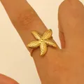 Dainty golden stainless steel starfish adjustable ring featuring a textured ocean theme design - Starfish Style (8338) / Gold