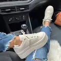 Close-up of stylish women's beige platform sneakers worn inside a modern vehicle - 35 / Off White